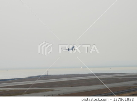 A passenger plane taking off from Kobe Airport 127861988