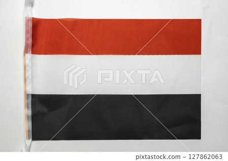 Closeup view of the Yemen national flag isolated over a white background. Concept of government and nationality 127862063