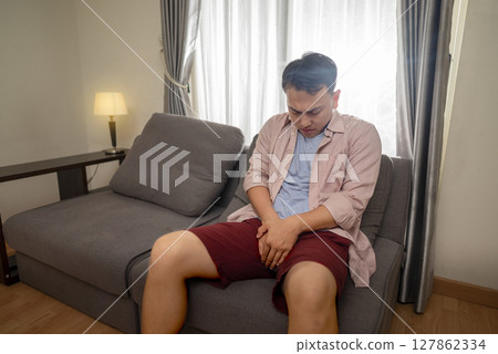 Indonesian southeast asian man having urinary tract infection or bladder infection, premature ejaculation, fertility, and prostate cancer disease. Healthcare concept 127862334