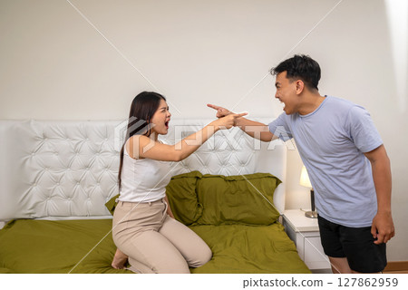 Indonesian southeast asian couple arguing in the bedroom. Having a crisis and difficulties in a relationship 127862959