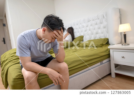 Indonesian southeast asian man disappointed in himself because of premature ejaculation and erectile problems. The man lost confidence with an unhappy and unsatisfied wife 127863005