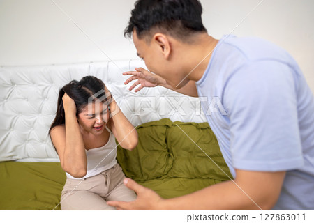 Indonesian southeast asian couple have an argument in the bedroom. Having a crisis and difficulties in a relationship Indonesian southeast asian couple have an argument in the bedroom. Having a crisis and difficulties in a relationship 127863011
