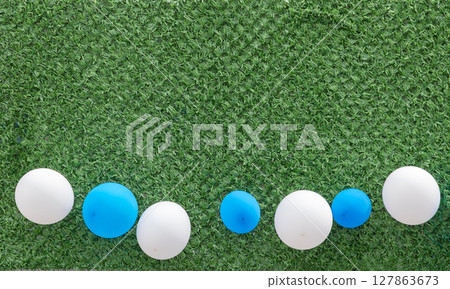 Balloons on grass background Balloons on grass background 127863673