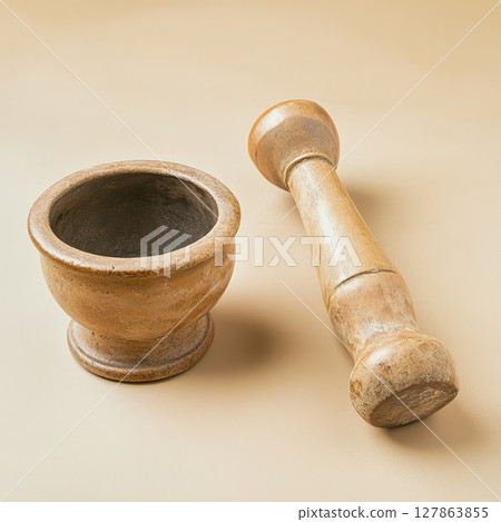 Mortar and pestle on a neutral background 127863855