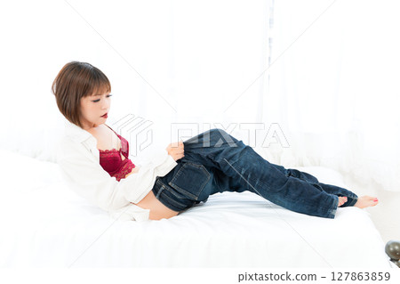 Woman wearing boyfriend's shirt and jeans Woman wearing boyfriend's shirt and jeans 127863859