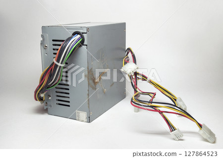 computer ATX power supply unit front side with ventilation holes. colorful power cords for conneting to drives are directly from non-modular case computer ATX power supply unit front side with ventilation holes. colorful power cords for conneting to drives are directly from non-modular case 127864523