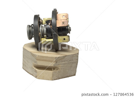 ignition starter switch, inner part with terminal set, on wooden stand 127864536