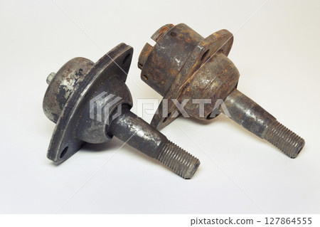 car ball joints pair. suspension component: threaded axis with ball bearing in metal socket with three mounting holes, old. on white background 127864555
