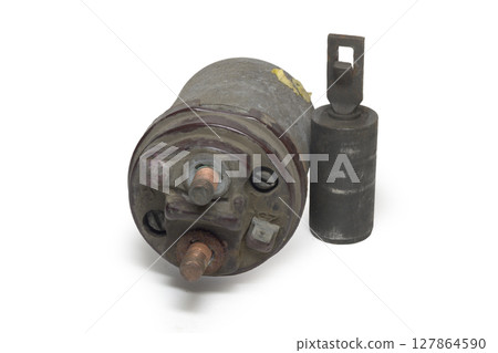 starter solenoid, with dusty copper threaded studs, with plunger with loop hole, extracted from the case. on white background, with clipping path 127864590