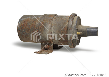 conventional ignition coil in clamp with holes for fixing the coil. old, worn. on white background, with clipping path 127864858