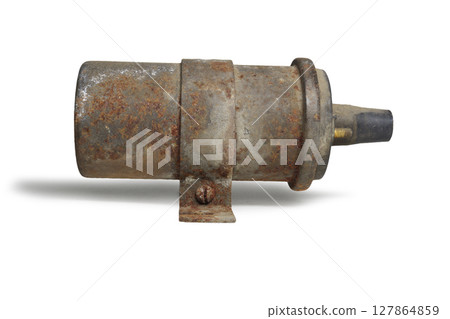conventional ignition coil in clamp with holes for fixing the coil. old, rusty. on white background, with clipping path 127864859