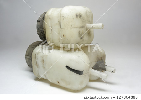 car fluid tanks of brake system and hydraulic clutch, piled together, upon each other, old, worn, dismantled to replace car fluid tanks of brake system and hydraulic clutch, piled together, upon each other, old, worn, dismantled to replace 127864883