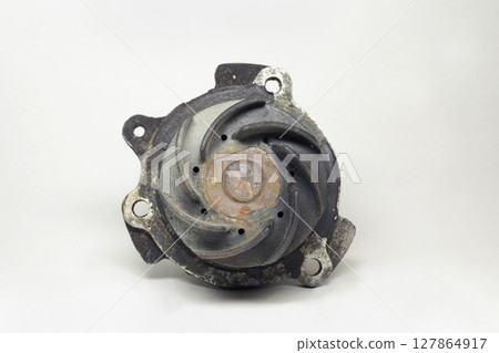 old rusty car water pump, showing plastic impeller with curved blades. with clipping path 127864917