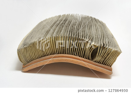 paper air filter, used, dusty, arc curved, because its old. on white background paper air filter, used, dusty, arc curved, because its old. on white background 127864930