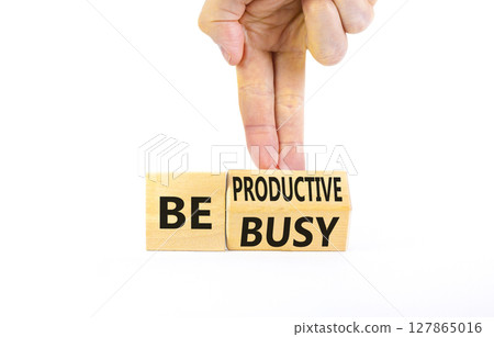 Be productive not busy symbol. Concept words Be productive Be busy on wooden block. Beautiful white table white background. Businessman hand. Business be productive not busy concept. Copy space. 127865016