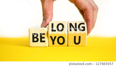 Belonging and belong symbol. Concept words Be you Belong on beautiful wooden block. Beautiful white background Businessman hand. Business motivational belonging and belong concept. Copy space. 127865057