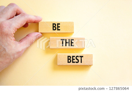 Motivational be the best symbol. Concept words Be the best on beautiful wooden blocks. Beautiful white background. Businessman hand. Business motivational be the best concept. Copy space. 127865064