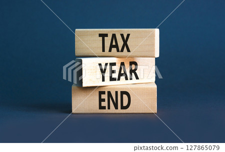 Tax year end symbol. Concept words Tax year end on beautiful wooden blocks. Beautiful grey table grey background. Business tax year end concept. Copy space. Tax year end symbol. Concept words Tax year end on beautiful wooden blocks. Beautiful grey table grey background. Business tax year end concept. Copy space. 127865079
