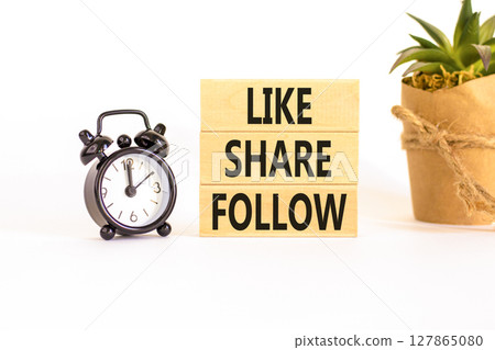 Like share follow symbol. Concept words Like Share Follow on beautiful wooden blocks. Beautiful white background. Black alarm clock. Business like share follow concept. Copy space. 127865080