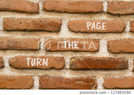 Turn the page symbol. Concept words Turn the page on beautiful brown brick wall. Beautiful brown brick wall background. Business motivational lifestyle turn the page concept. Copy space. 127865098