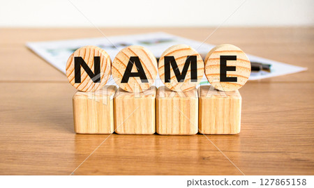 Name symbol. Concept word Name on beautiful wooden circles on wooden blocks. Beautiful wooden table white background. Business, lifestyle, support and name concept. Copy space. 127865158