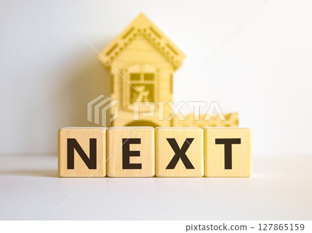 Next symbol. Concept word Next on beautiful wooden blocks. Beautiful white table white background. Wooden beautiful house. Business, lifestyle, support and next concept. Copy space. 127865159