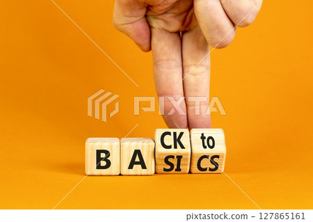 Back to basics symbol. Concept words Back to basics on wooden block. Beautiful orange table orange background. Businessman hand. Business back to basics concept. Copy space. 127865161