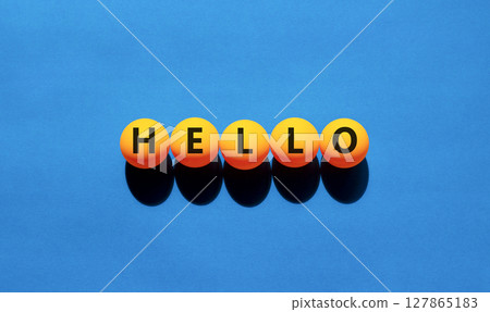 Hello symbol. Concept word Hello on beautiful yellow tennis ping pong balls. Beautiful wooden table wooden background. Business lifestyle hello concept. Copy space. 127865183