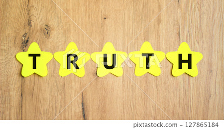 Truth symbol. Concept word Truth on beautiful yellow paper stars. Beautiful wooden table wooden background. Business lifestyle truth concept. Copy space. 127865184