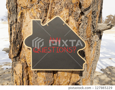 Any questions symbol. Concept words Any questions on beautiful black house blackboard. Beautiful tree background. Business and Any questions Q and A concept, copy space. 127865229