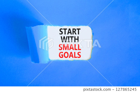 Start with small goals symbol. Concept words phrase Start with small goals on beautiful white paper. Beautiful blue paper background. Business Start with small goals concept. Copy space. Start with small goals symbol. Concept words phrase Start with small goals on beautiful white paper. Beautiful blue paper background. Business Start with small goals concept. Copy space. 127865245