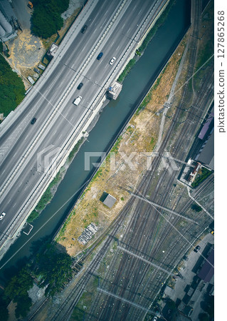 Aerial view of highway and railway intersection with canal Aerial view of highway and railway intersection with canal 127865268