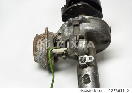 distributor of conventional ignition system. capacitor, vacuum control unit, rotor housing close-up distributor of conventional ignition system. capacitor, vacuum control unit, rotor housing close-up 127865340