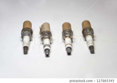 spark plug set, worn, corrosion, used, in cardboard packaging for thread spark plug set, worn, corrosion, used, in cardboard packaging for thread 127865345