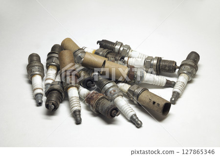 spark plugs big heap, old. Used copper plugs on white background spark plugs big heap, old. Used copper plugs on white background 127865346
