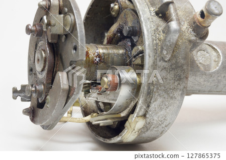 distributor of mechanical ignition system. contact breaker closeup distributor of mechanical ignition system. contact breaker closeup 127865375