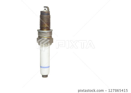 used spark plug, blue strip on body of white insulator, isolated on white background used spark plug, blue strip on body of white insulator, isolated on white background 127865415