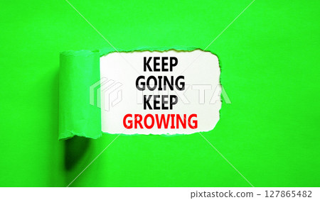 Keep going and growing symbol. Concept words phrase Keep going keep growing on beautiful white paper. Beautiful green paper background. Business Keep going and growing concept. Copy space. 127865482