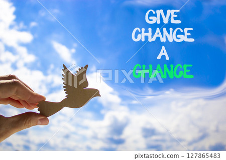 Give change a chance symbol. Concept words phrase Give change a chance on blue sky. Businessman's hand. Beautiful blue sky clouds background. Business Give change a chance concept. Copy space. Give change a chance symbol. Concept words phrase Give change a chance on blue sky. Businessman's hand. Beautiful blue sky clouds background. Business Give change a chance concept. Copy space. 127865483