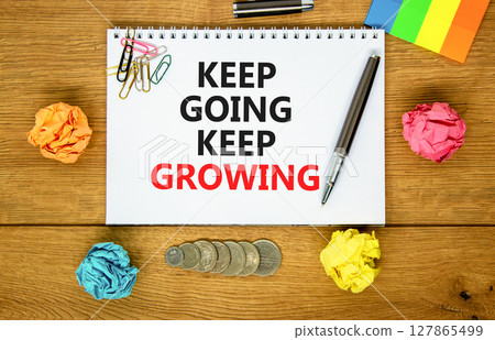 Keep going and growing symbol. Concept words phrase Keep going keep growing on beautiful white note. Colored paper. Beautiful wooden background. Business Keep going and growing concept. Copy space. Keep going and growing symbol. Concept words phrase Keep going keep growing on beautiful white note. Colored paper. Beautiful wooden background. Business Keep going and growing concept. Copy space. 127865499