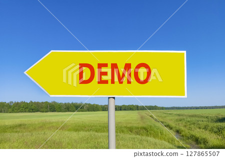 Demo symbol. Concept word Demo on beautiful yellow road sign. Beautiful blue sky green grass and forest peaceful nature background. Business and demo concept. Copy space. 127865507