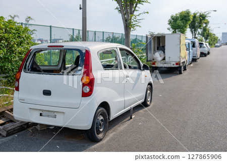 Abandoned vehicles on the road 127865906