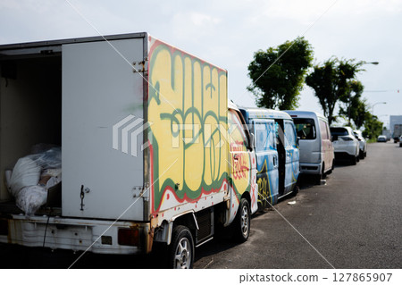 Abandoned vehicles on the road 127865907