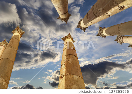 Roman Columns in the Jordanian city of Jerash (Gerasa of Antiquity), capital and largest city of Jerash Governorate, Jordan. Against the background of a beautiful sky with clouds 127865956