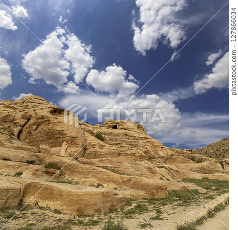 Mountains of Petra (against the background of a beautiful sky with clouds), Jordan, Middle East. Petra has been a UNESCO World Heritage Site since 1985 127866034