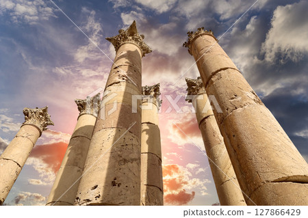 Roman Columns in the Jordanian city of Jerash (Gerasa of Antiquity), capital and largest city of Jerash Governorate, Jordan. Against the background of a beautiful sky with clouds Roman Columns in the Jordanian city of Jerash (Gerasa of Antiquity), capital and largest city of Jerash Governorate, Jordan. Against the background of a beautiful sky with clouds 127866429