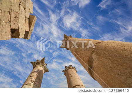 Roman Columns in the Jordanian city of Jerash (Gerasa of Antiquity), capital and largest city of Jerash Governorate, Jordan. Against the background of a beautiful sky with clouds Roman Columns in the Jordanian city of Jerash (Gerasa of Antiquity), capital and largest city of Jerash Governorate, Jordan. Against the background of a beautiful sky with clouds 127866440