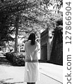 Girl looking at tree 127866904