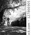 Girl walking in the shade 127866905