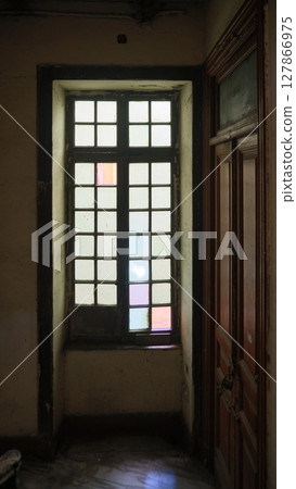 Old wooden window with frosted glass in dim hallway 127866975